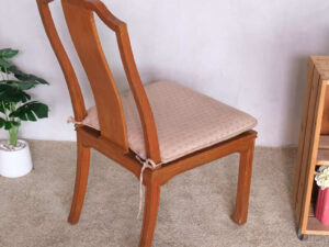 Wooden chair, patterned fabric cushion, beautiful frame.