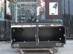 Jewelry cabinet, glass product display cabinet with 4 opening doors, black wood frame, with LED lights along the glass edges.