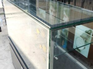 Jewelry cabinet, glass product display cabinet with 4 opening doors, black wood frame, with LED lights along the glass edges.