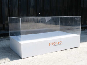Clear acrylic product display shelf, white wooden frame, wide horizontal.