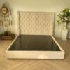 Bed 6 feet, wooden frame, fabric covered, cream color.