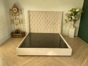 Bed 6 feet, wooden frame, fabric covered, cream color.