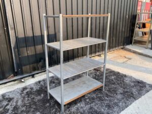 4 shelves, steel frame, wooden top, gray color.