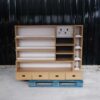 Product shelves, 2 sides, brown wooden frame. The bottom has 4 storage drawers on each side.