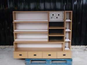 Product shelves, 2 sides, brown wooden frame. The bottom has 4 storage drawers on each side.
