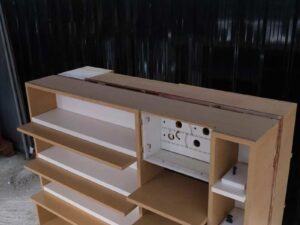 Product shelves, 2 sides, brown wooden frame. The bottom has 4 storage drawers on each side.