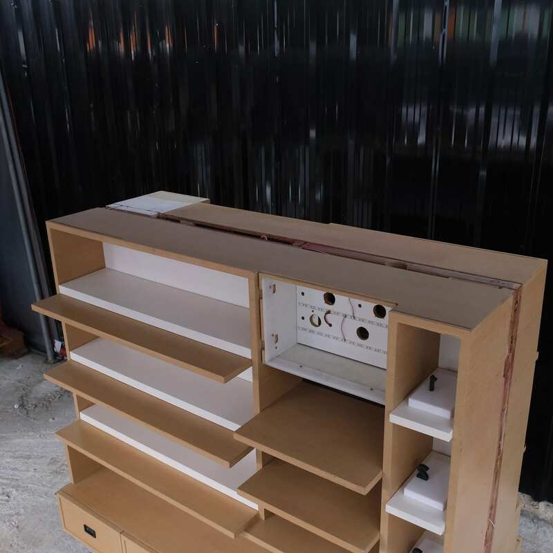 Product shelves, 2 sides, brown wooden frame. The bottom has 4 storage drawers on each side.
