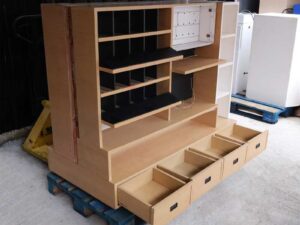 Product shelves, 2 sides, brown wooden frame. The bottom has 4 storage drawers on each side.
