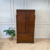 Wooden wardrobe with 2 doors, wooden frame, brown color.