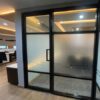 Glass door, blackened aluminum frame