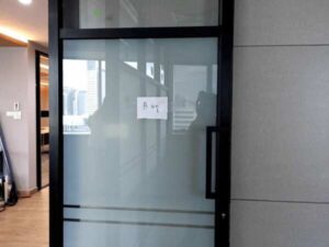 Glass door, blackened aluminum frame
