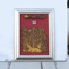 Picture of a golden forest with a red background, silver frame