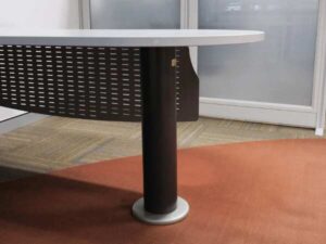 Executive desk, L-shaped corner, light gray wood top, steel legs, has a steel plate to shield the view under the desk, brand UB.