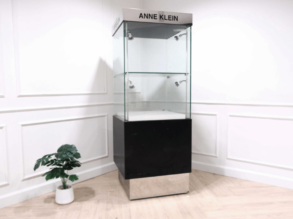Tall glass product display cabinet, black color, glass door opening.