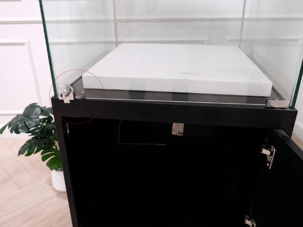 Tall glass product display cabinet, black color, glass door opening.