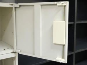 Tall steel filing cabinet, 2 doors, open on 3 lower levels.