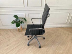 Office chair with black leather upholstery, high back, steel frame, steel arms and legs, adjustable height-low.