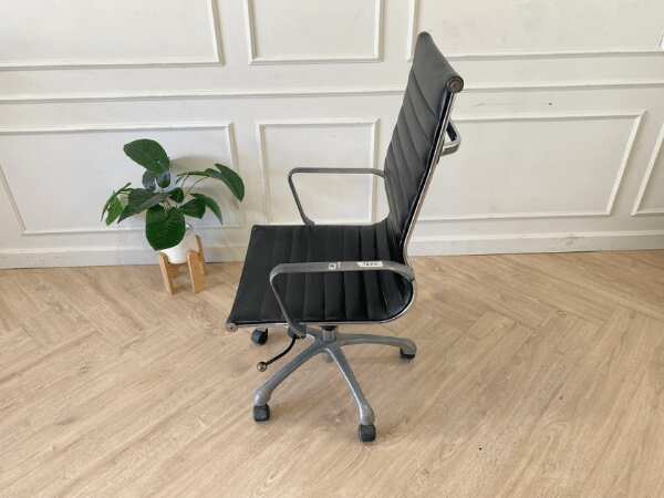Office chair with black leather upholstery, high back, steel frame, steel arms and legs, adjustable height-low.