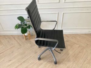 Office chair with black leather upholstery, high back, steel frame, steel arms and legs, adjustable height-low.