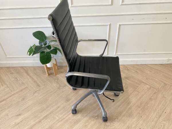 Office chair with black leather upholstery, high back, steel frame, steel arms and legs, adjustable height-low.