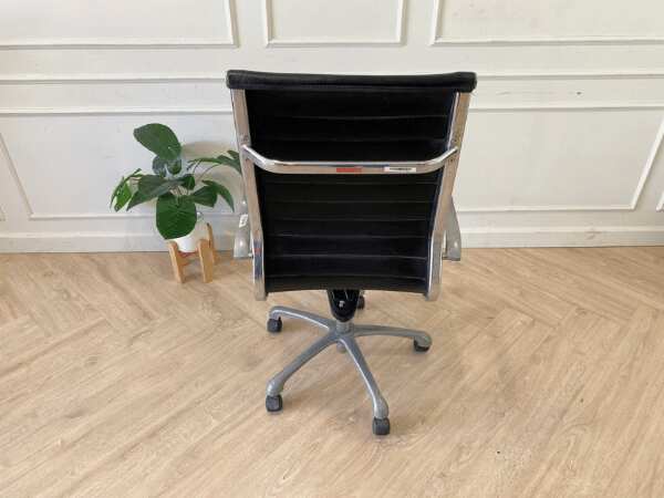 Office chair with black leather upholstery, high back, steel frame, steel arms and legs, adjustable height-low.