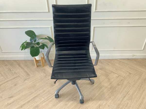 Office chair with black leather upholstery, high back, steel frame, steel arms and legs, adjustable height-low.