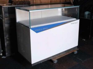 Jewelry cabinet, glass cabinet to display products Rectangular shape glass door open White wooden base with blue stripes