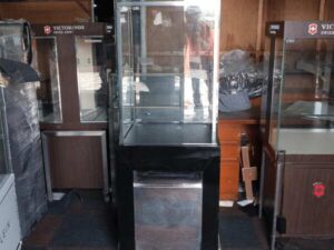 Jewelry cabinet, glass cabinet to display products Tall, square shape glass door open Black wooden base with silver trim