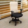 office chair Cream leather backrest, black cloth cushion, with arms.