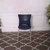 Blue cushioned chair, steel legs, no arms.