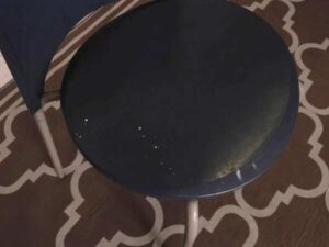 Blue cushioned chair, steel legs, no arms.