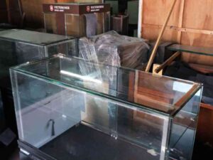 Jewelry cabinet, glass cabinet to display products Rectangular shape glass door open Black wooden base with silver trim