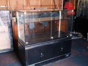 Jewelry cabinet, glass cabinet to display products Rectangular shape glass door open Black wooden base with silver trim