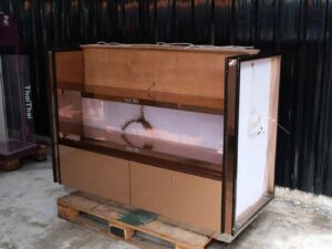 Product shelves, 2 sides, 2 shelves on each side, 2 drawers, wooden frame with gold stainless steel edges. There is a light sign on the side.