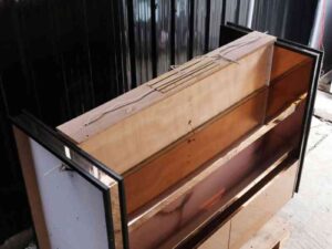 Product shelves, 2 sides, 2 shelves on each side, 2 drawers, wooden frame with gold stainless steel edges. There is a light sign on the side.