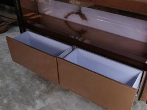 Product shelves, 2 sides, 2 shelves on each side, 2 drawers, wooden frame with gold stainless steel edges. There is a light sign on the side.