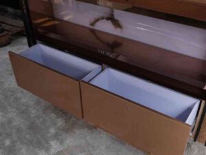Product shelves, 2 sides, 2 shelves on each side, 2 drawers, wooden frame with gold stainless steel edges. There is a light sign on the side.