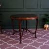 Round table, carved wood European work comes from Germany.