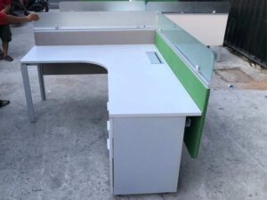 L-shaped corner desk with light gray filing cabinet and partition.