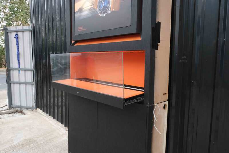 Jewelry display case, glass showcase, 2-tier display case, black wooden frame, 2 open doors, 1 glass drawer.