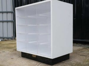 White wooden frame shelving unit with plastic shelves, 15 compartments.