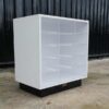 White wooden frame shelving unit with plastic shelves, 15 compartments.