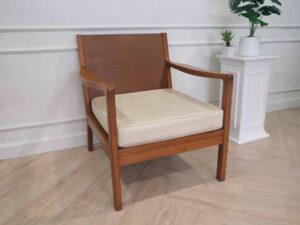 Chair with armrests, wooden frame. Seat cushion made of fabric.