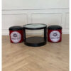 Brown vintage round table + red vintage chairs, black seats, round shape.