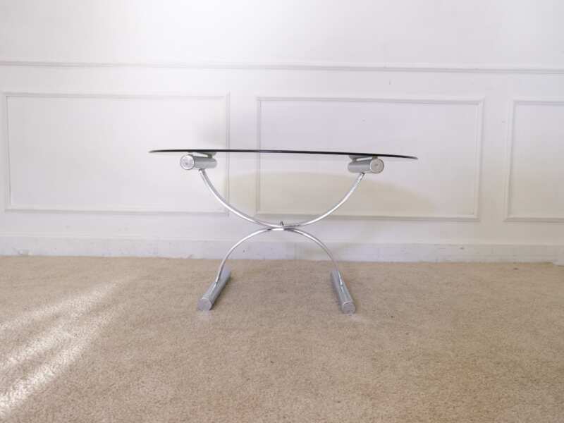 Center table, round glass top, silver steel legs.