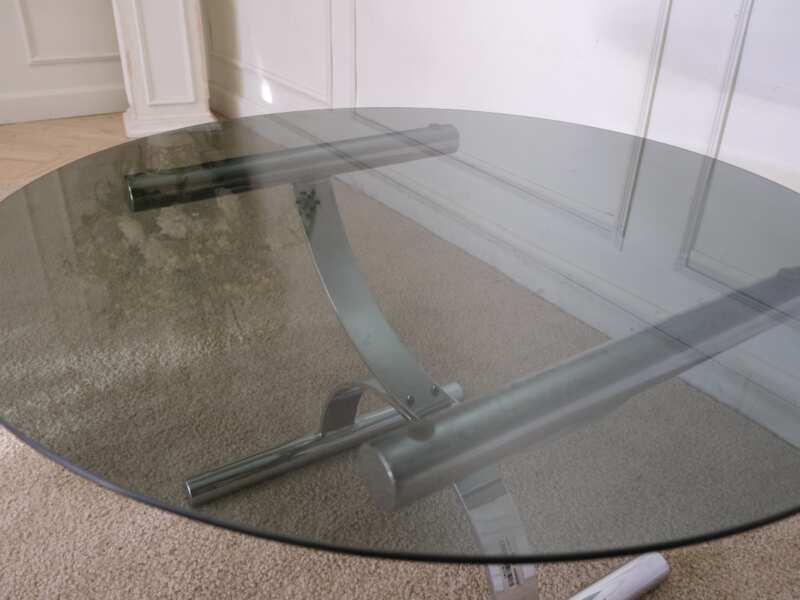 Center table, round glass top, silver steel legs.