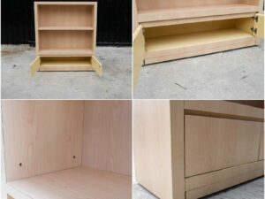 Product shelf, 2-level shelves, 2 storage cabinets with open doors, light brown wooden frame.