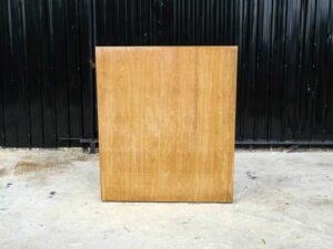Product shelf, 2-level shelves, 2 storage cabinets with open doors, light brown wooden frame.