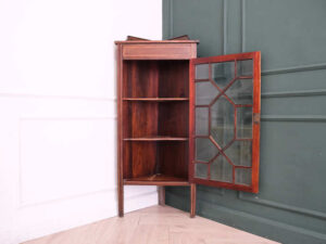 Mahogany corner display cabinet with 1 glass door.