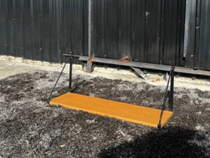 Hanging shelf, black steel frame, wooden top.